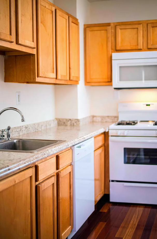 a kitchen with wooden cabinets and white appliances