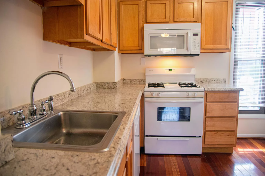 a kitchen with a sink stove and microwave