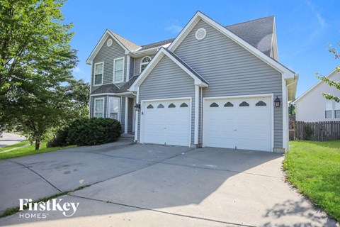 A two-story house with a garage is for sale.