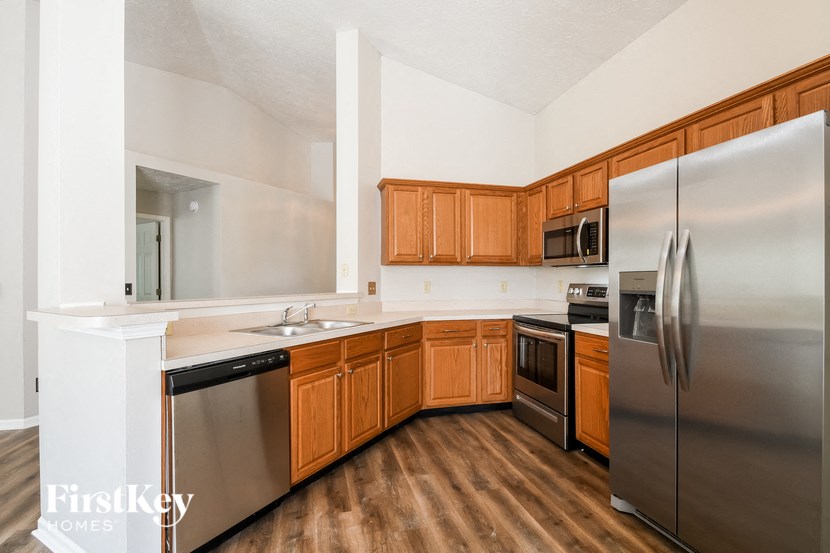 a kitchen with stainless steel appliances and wooden cabinets