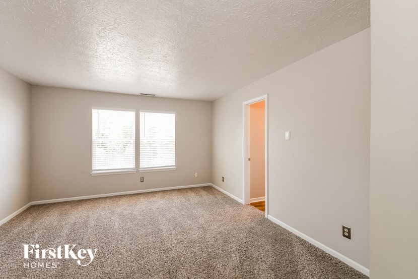 an empty room with a window and a door
