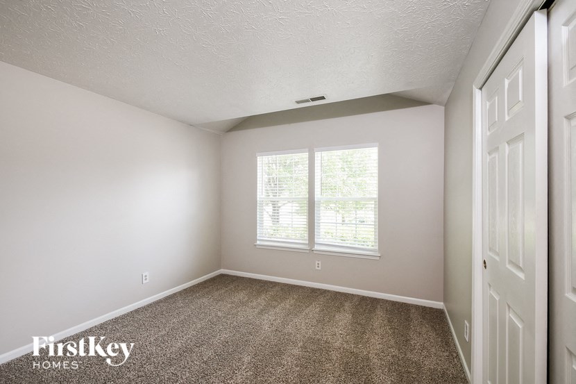 the living room of an empty house with a window