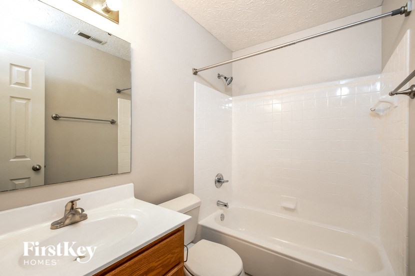 a bathroom with a sink toilet and a tub