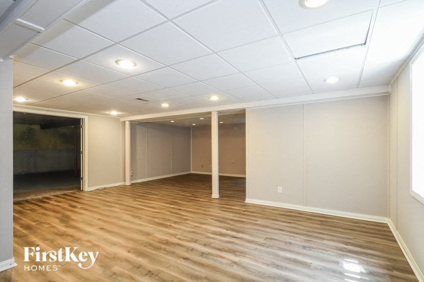 a living room with a wooden floor and white walls