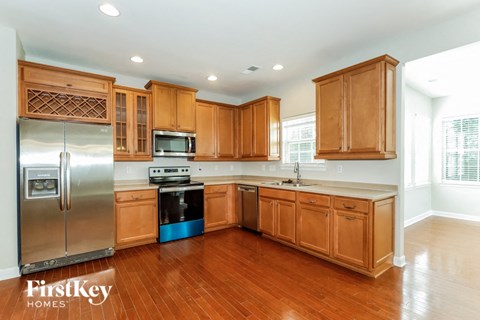 a kitchen with wooden cabinets and stainless steel appliances