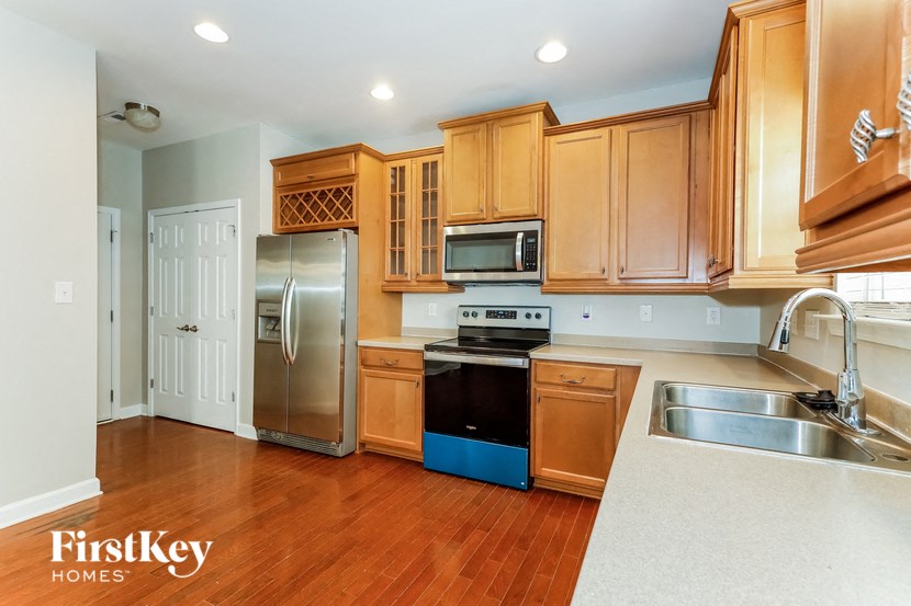 a kitchen with wooden cabinets and stainless steel appliances