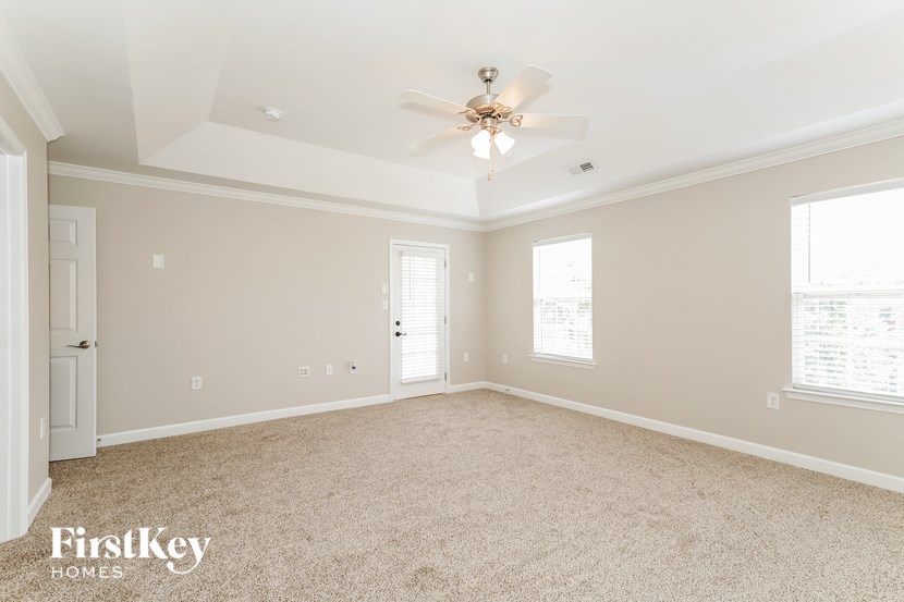 a bedroom with carpet and a ceiling fan