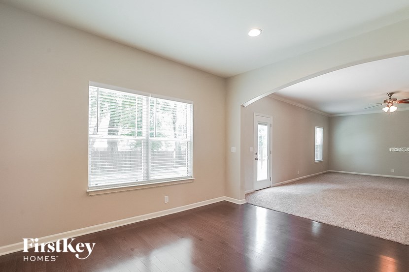 an empty living room with a large window and a door