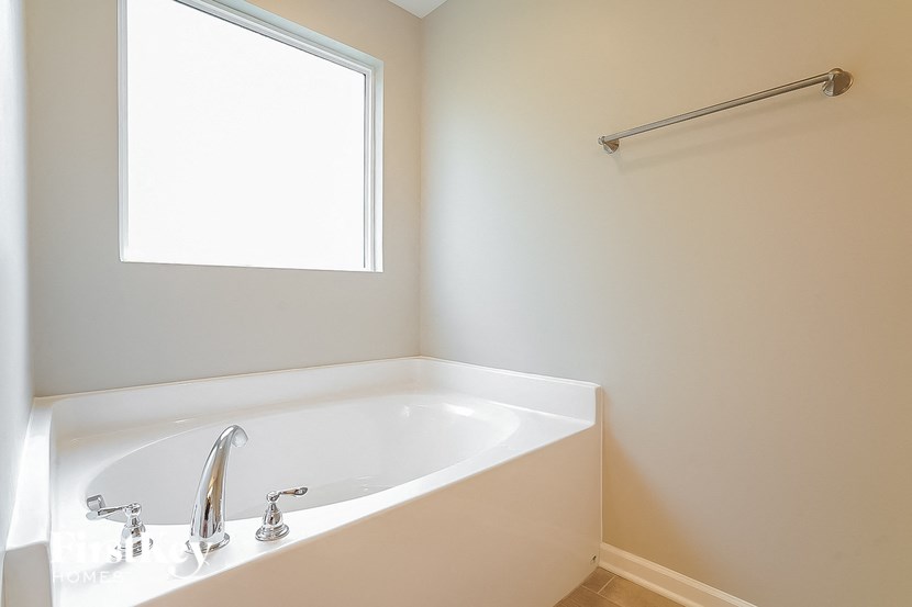 a bathroom with a bath tub and a window