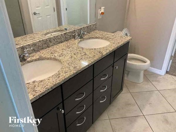 a bathroom with two sinks and a toilet