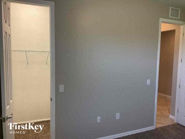 an empty room with a closet and a door