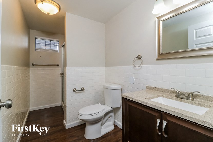 a bathroom with a toilet and a sink and a mirror
