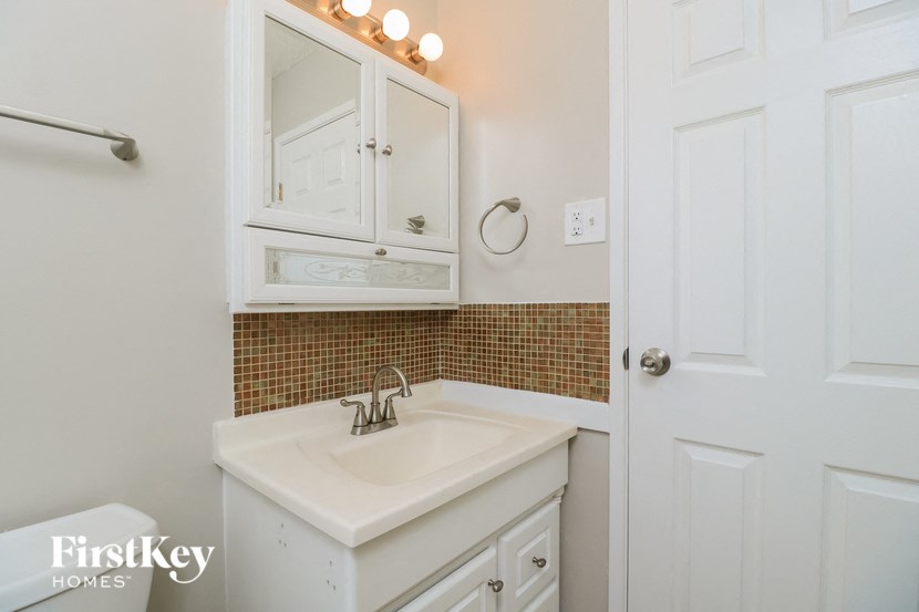 a white bathroom with a sink and a mirror