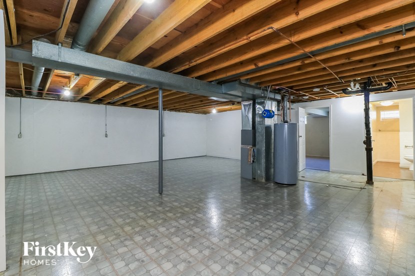 an empty garage with a tile floor and a wood ceiling