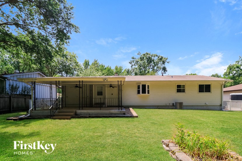 a white house with a yard and a porch