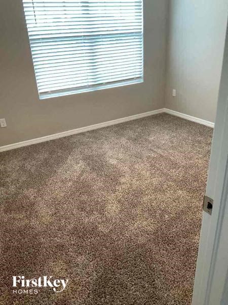 a carpeted floor in a room with a window
