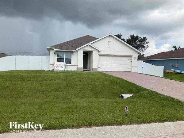a white house with a lawn in front of it