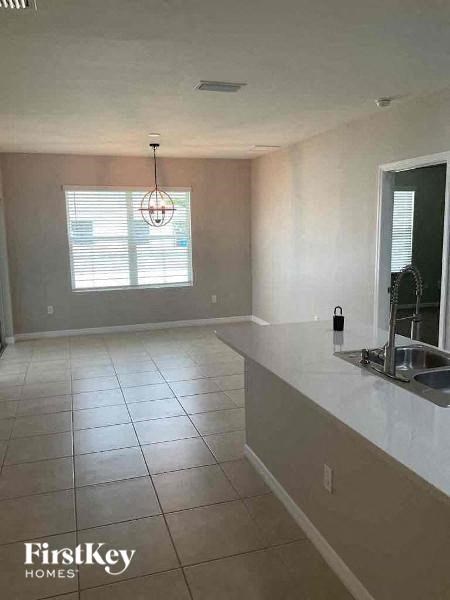 an empty kitchen with a sink and a counter top
