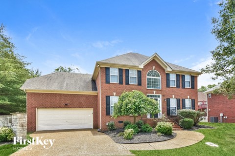 a brick house with a white garage door