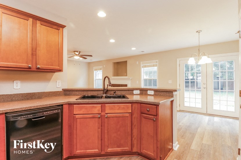 a kitchen with wooden cabinets and a sink and a dishwasher