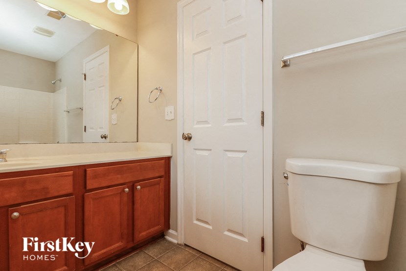 a bathroom with a toilet and a sink and a mirror
