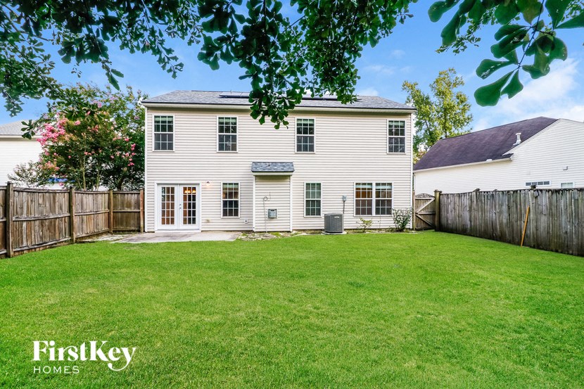 a white house with a yard and a fence