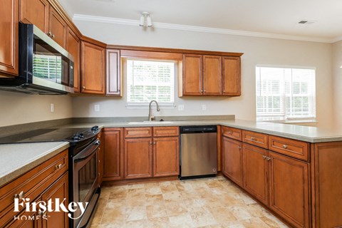 a kitchen with wooden cabinets and stainless steel appliances