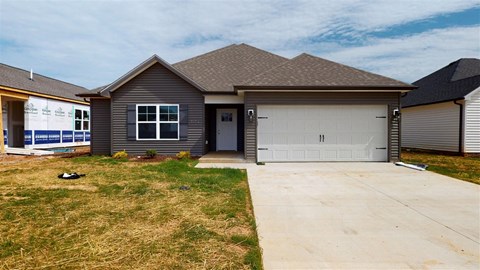 a house with a white garage door and a driveway