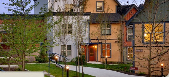 A building with a red door is lit up at night.