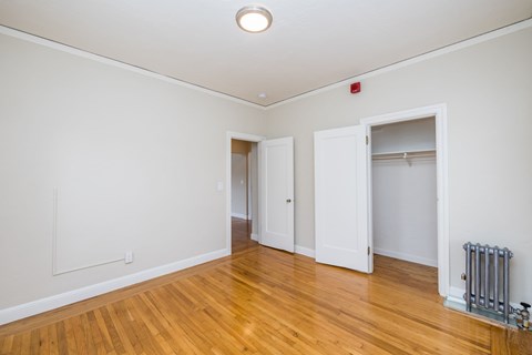 A room with a wooden floor and white walls.