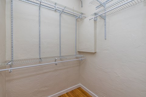 A white wall with a metal rack on it.