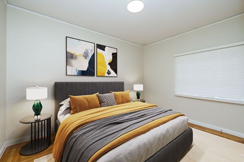 A bedroom with a large bed and two lamps.