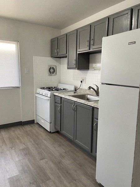 a kitchen with a stove and a refrigerator