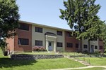 a building with a lawn and trees in front of it