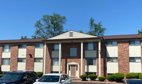 A large brick building with a white door and windows.