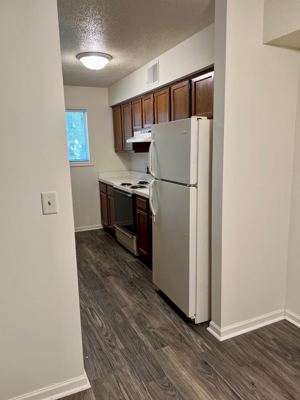 a kitchen with a refrigerator and a stove and