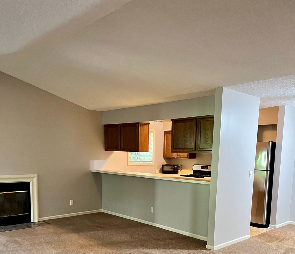 an empty kitchen with a stove and a refrigerator