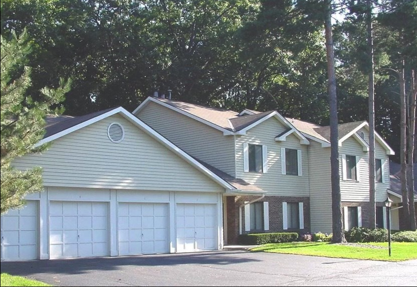 a house with a garage and a white garage door