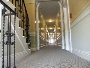A long hallway with a staircase on the left side.
