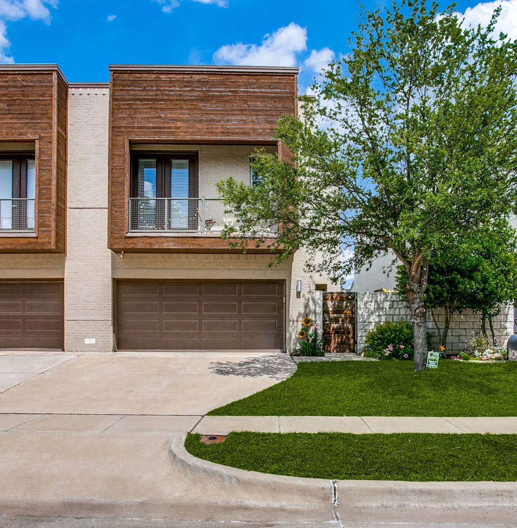 a house with a driveway and two garage doors
