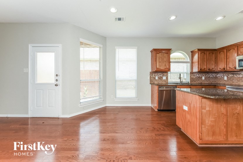 A kitchen with wooden cabinets and a countertop.
