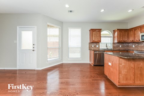 A kitchen with wooden cabinets and a countertop.