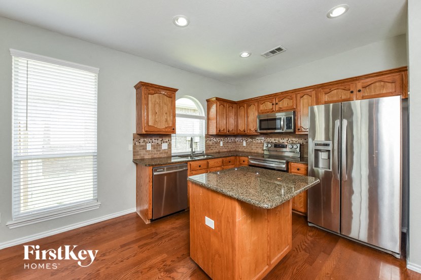 A kitchen with wooden cabinets and stainless steel appliances.
