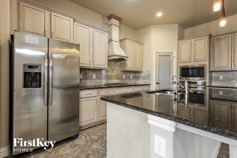 a kitchen with granite counter tops and stainless steel appliances