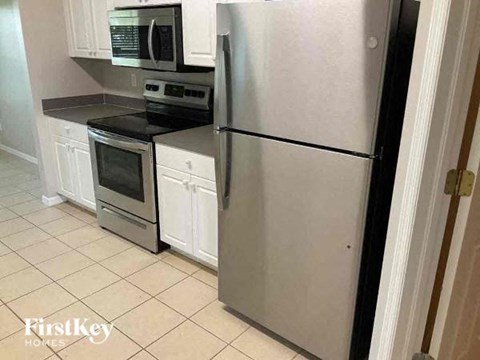 a kitchen with a stainless steel refrigerator and stove