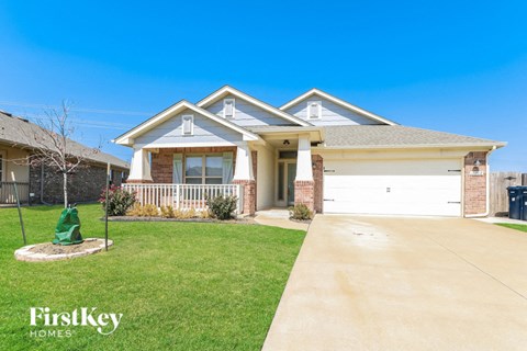 a home with a white garage door and a lawn
