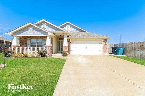 a house with a driveway and lawn in front of it