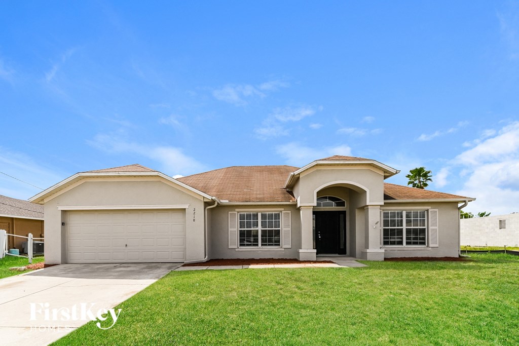 A house with a brown roof and a garage door.