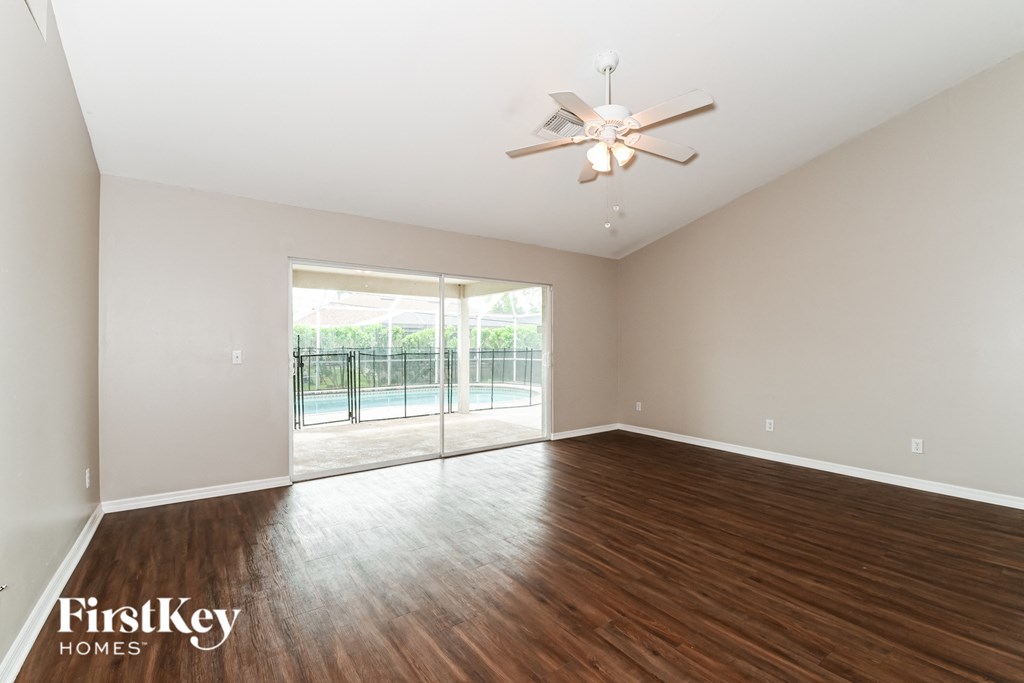 A room with wooden floors and a ceiling fan.