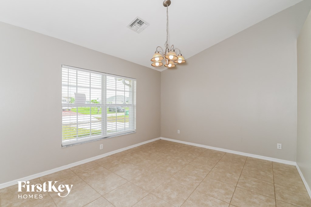 A room with a FirstKey Homes logo on the bottom left corner.